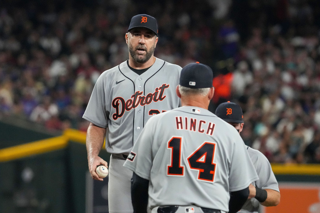 Detroit Tigers pitcher Justin Verlander prepares to hand off the ball to manager A.J. Hinch during the fourth inning of an opening-day baseball game against the Arizona Diamondbacks Monday, March 30, 2026, in Phoenix. (AP Photo/Darryl Webb)