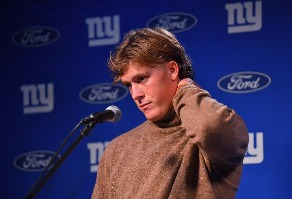 New York Giants quarterback Jaxson Dart reacts during a news conference while talking to the media after a loss to the New England Patriots in an NFL football game Monday, Dec. 1, 2025, in Foxborough, Mass. (AP Photo/Steven Senne)