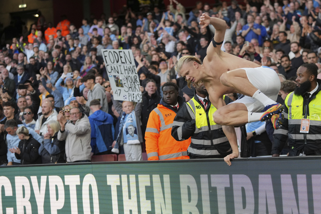 Manchester City's Erling Haaland jumps the board after the Premier League soccer match between Arsenal and Manchester City in London, Sunday, Sept. 21, 2025. (AP Photo/Kin Cheung)