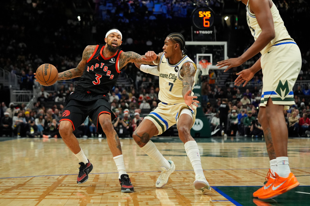 Toronto Raptors' Brandon Ingram (3) drives to the basket against Milwaukee Bucks' Kevin Porter Jr. during the first half of an NBA basketball game, Thursday, Dec. 18, 2025, in Milwaukee. (AP Photo/Aaron Gash)