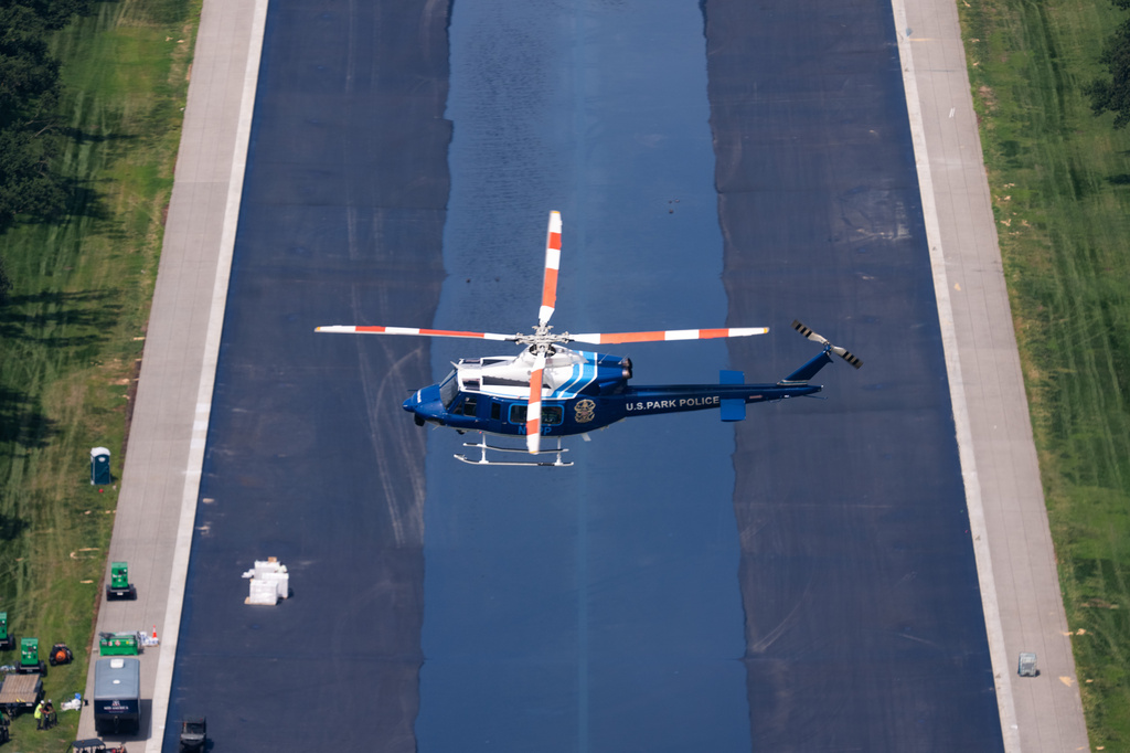 A U.S. Park Police helicopter flies over the Lincoln Memorial Reflecting Pool as it begins to refill with water, Friday, June 5, 2026, in Washington. (AP Photo/Allison Robbert)
