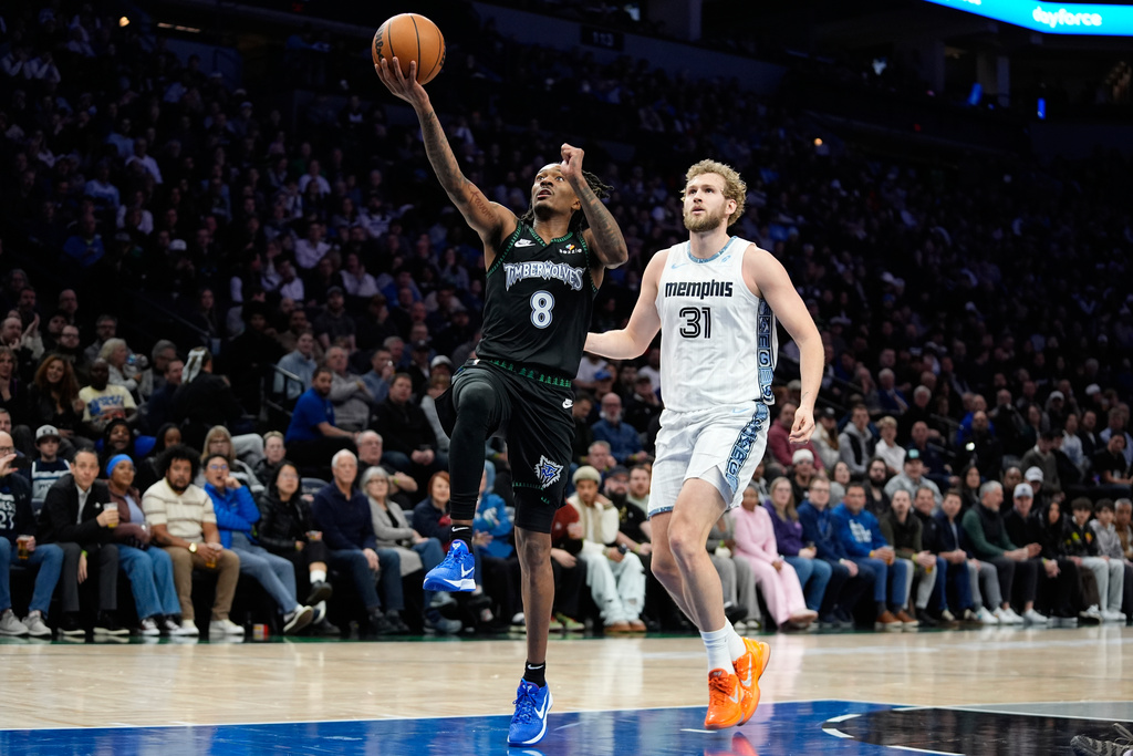 Minnesota Timberwolves guard Bones Hyland (8) goes up for a shot as Memphis Grizzlies center Jock Landale (31) follows during the first half of an NBA basketball game, Wednesday, Dec. 17, 2025, in Minneapolis. (AP Photo/Abbie Parr)