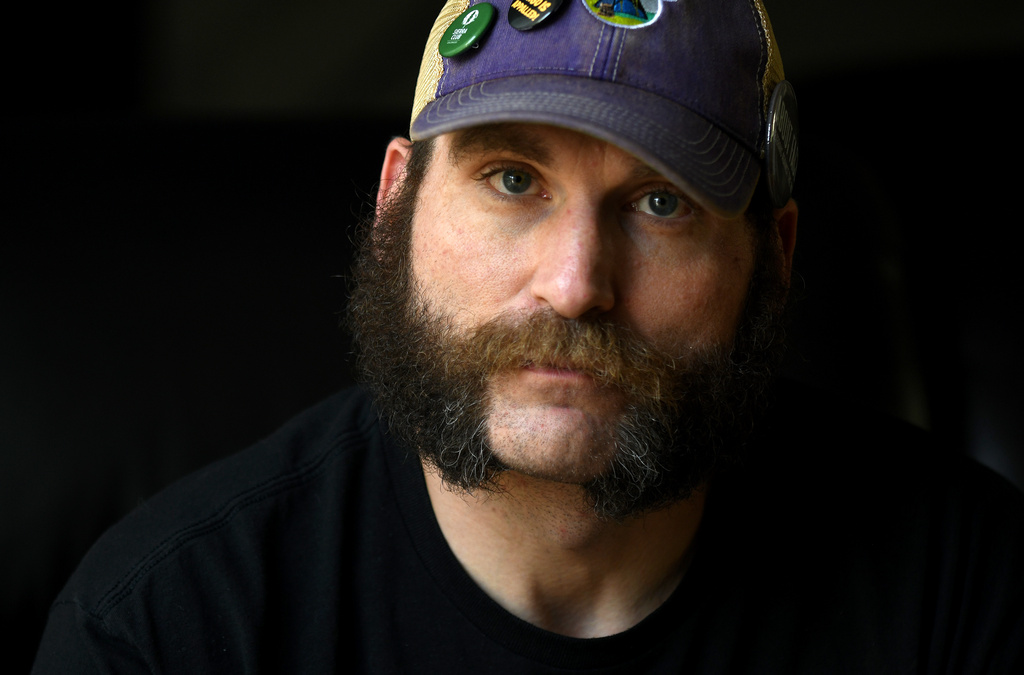 Joe Shearer, who was diagnosed with traumatic brain injuries from fighting in Iraq, poses for a portrait in his home in Colorado Springs, Colo., Wednesday, Aug. 5, 2026. (AP Photo/Thomas Peipert)
