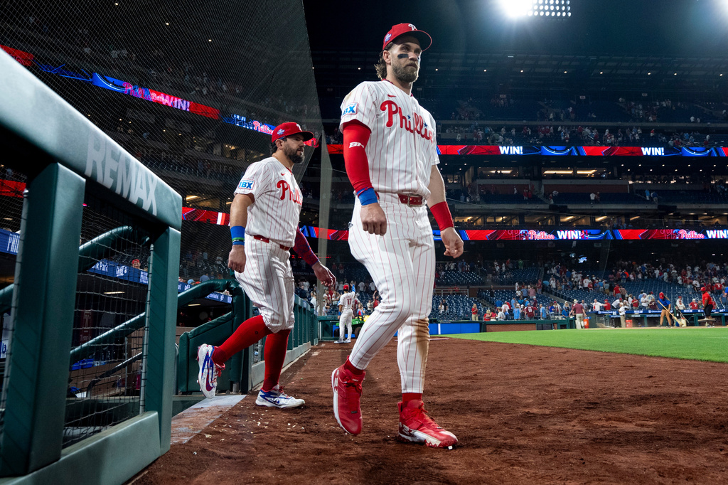 Philadelphia Phillies' Bryce Harper, right, and Kyle Schwarber, left, comes back out to do TV interviews after a baseball game against the New York Mets, Saturday, June 20, 2026, in Philadelphia. (AP Photo/Chris Szagola)