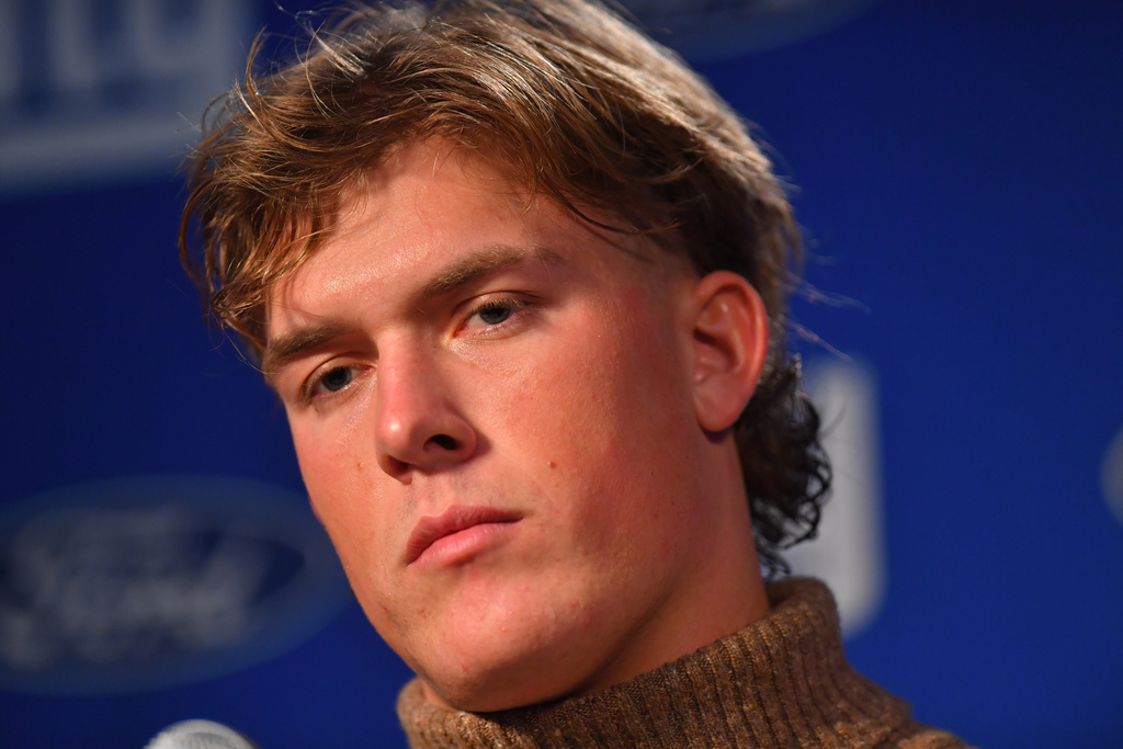 New York Giants quarterback Jaxson Dart reacts during a news conference while talking to the media after a loss to the New England Patriots in an NFL football game Monday, Dec. 1, 2025, in Foxborough, Mass. (AP Photo/Steven Senne)