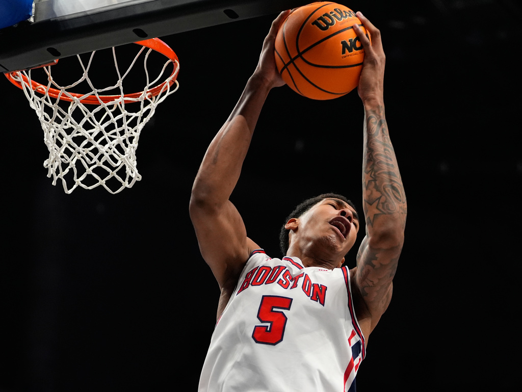 Houston's Chris Cenac Jr. reaches for a rebound during the first half of an NCAA college basketball game against Kansas in the semifinal round of the Big 12 Conference tournament Friday, March 13, 2026, in Kansas City, Mo. (AP Photo/Charlie Riedel)