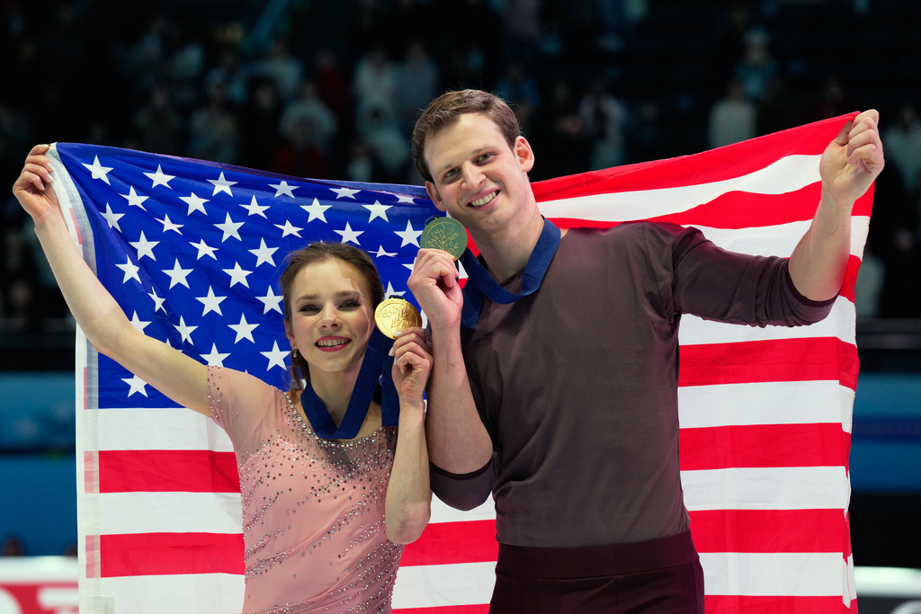 Gold medalists Alisa Efimova and Misha Mitrofanov of the United States celebrate with their national flag and medals after the Pairs Free Skating of the ISU Four Continents Figure Skating Championships in Beijing, China, Saturday, Jan. 24, 2026. (AP Photo/Vincent Thian)