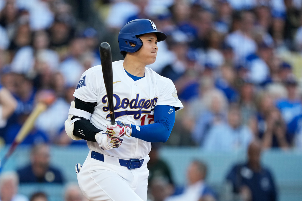 Los Angeles Dodgers designated hitter Shohei Ohtani hits a single against the Arizona Diamondbacks during the first inning of an opening-day baseball game Thursday, March 26, 2026, in Los Angeles. (AP Photo/Mark J. Terrill)