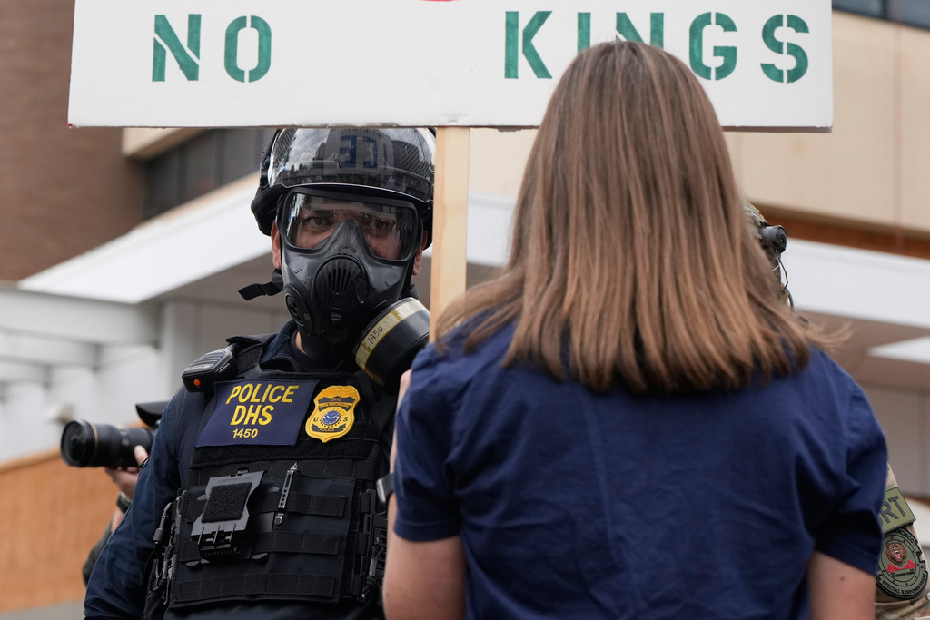 A Department of Homeland Security officer stands off against a demonstrator outside a U.S. Immigration and Customs Enforcement facility on Saturday, Oct. 4, 2025, in Portland, Ore. (AP Photo/Jenny Kane)