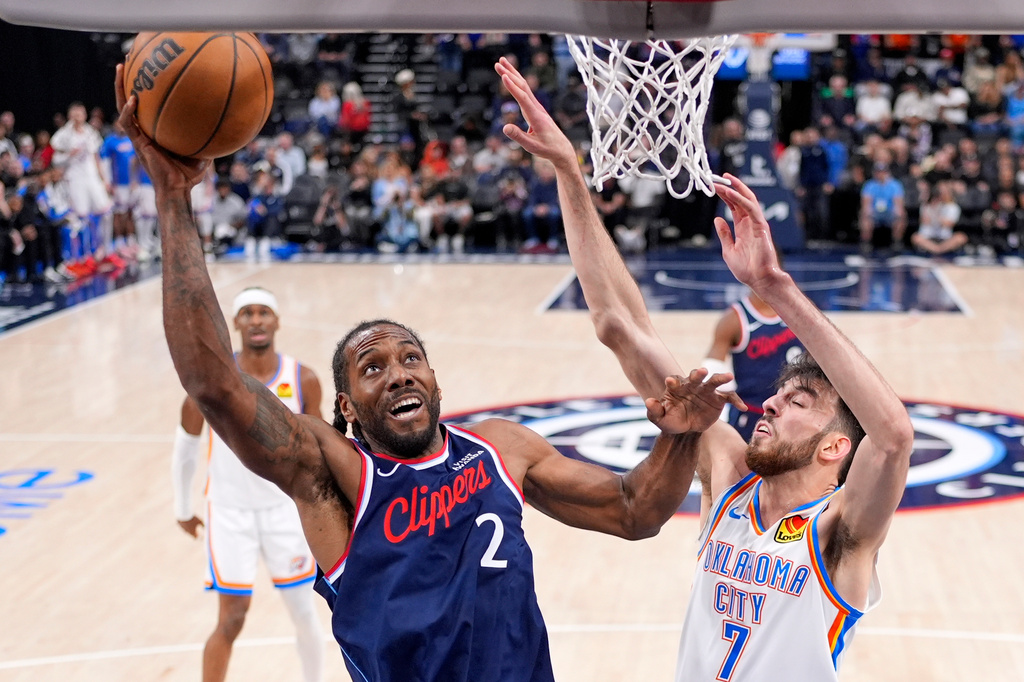 Los Angeles Clippers forward Kawhi Leonard, left, shoots as Oklahoma City Thunder center Chet Holmgren defends during the first half of an NBA basketball game Wednesday, April 8, 2026, in Inglewood, Calif. (AP Photo/Mark J. Terrill)