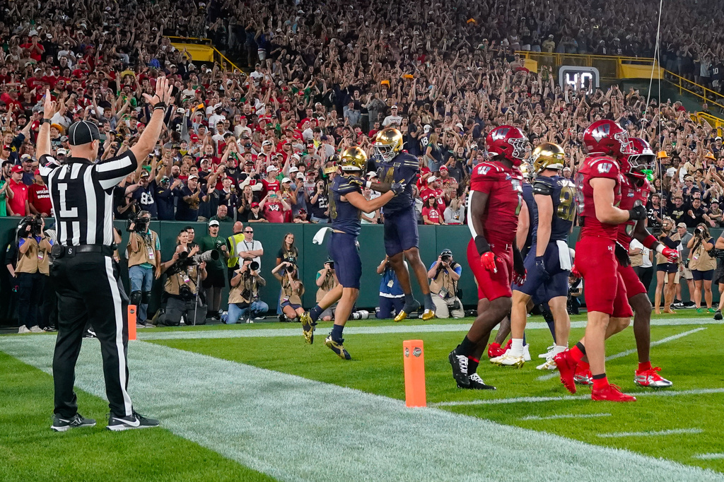 Notre Dame tight end James Flanigan, center left, and teammate Micah Gilbert, center right, celebrate a touchdown during the first half of an NCAA college football game against Wisconsin Sunday, Sept. 6, 2026, in Green Bay, Wis. (AP Photo/Kayla Wolf)