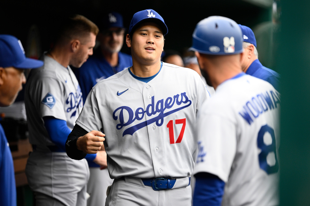 Los Angeles Dodgers' Shohei Ohtani (17) walks in the dugout before a baseball game against the Washington Nationals, Sunday, April 5, 2026, in Washington. (AP Photo/Nick Wass)