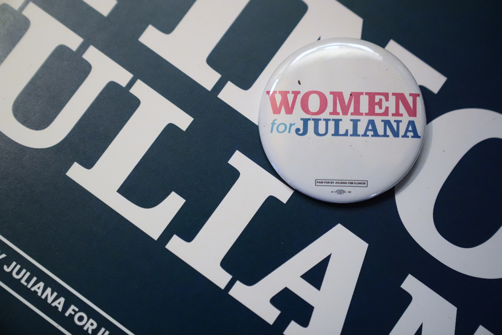 A pin reading "women for Juliana" is displayed during a primary election night watch party for Illinois Lt. Gov. Juliana Stratton, a Democratic candidate for U.S. Senate, Tuesday, March 17, 2026, in Chicago. (AP Photo/Erin Hooley)