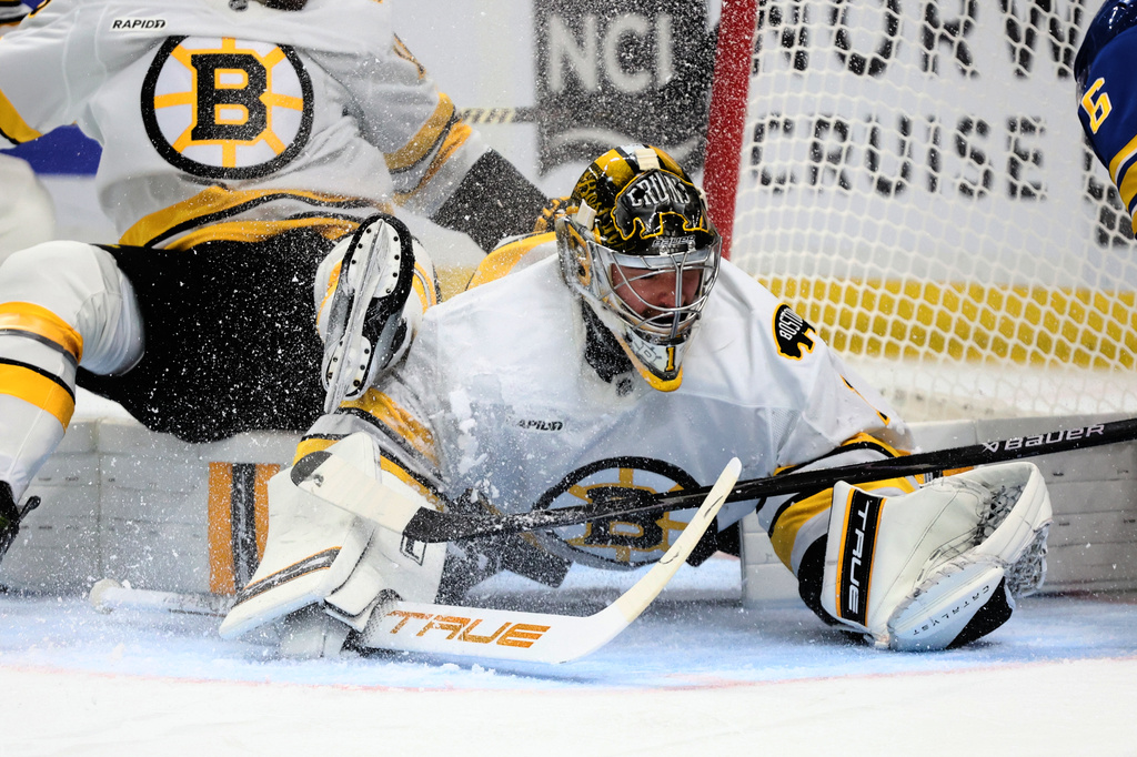 Boston Bruins goaltender Jeremy Swayman (1) makes a save in traffic during the first period in Game 2 of a first-round NHL hockey Stanley Cup playoff series against the Buffalo Sabres Tuesday, April 21, 2026, in Buffalo, N.Y. (AP Photo/Jeffrey T. Barnes)