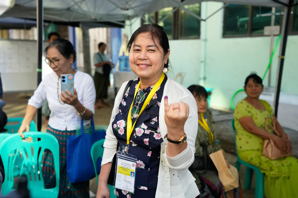 Sandar Min, an individual candidate for an election and former parliament member from ousted leader Aung San Suu Kyi's National League for Democracy (NLD) party, shows off her finger marked with ink indicating she voted at a polling station during the second phase of general election Sunday, Jan. 11, 2026, in Yangon, Myanmar. (AP Photo/Thein Zaw)