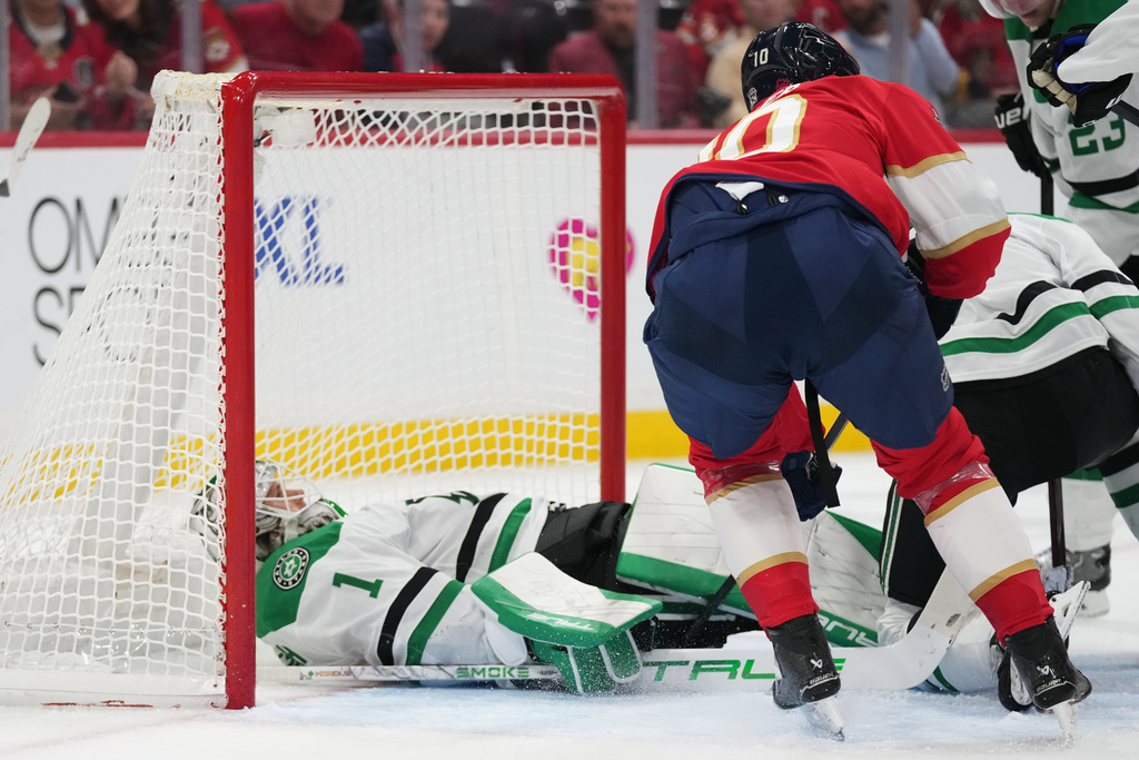 Dallas Stars goaltender Casey DeSmith (1) falls into the net during the second period of an NHL hockey game against the Florida Panthers, Saturday, Nov. 1, 2025, in Sunrise, Fla. (AP Photo/Lynne Sladky)