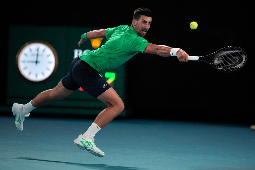 Novak Djokovic of Serbia plays a backhand return to Botic van de Zandschulp of the Netherlands during their third round match at the Australian Open tennis championship in Melbourne, Australia, Saturday, Jan. 24, 2026. (AP Photo/Dita Alangkara)