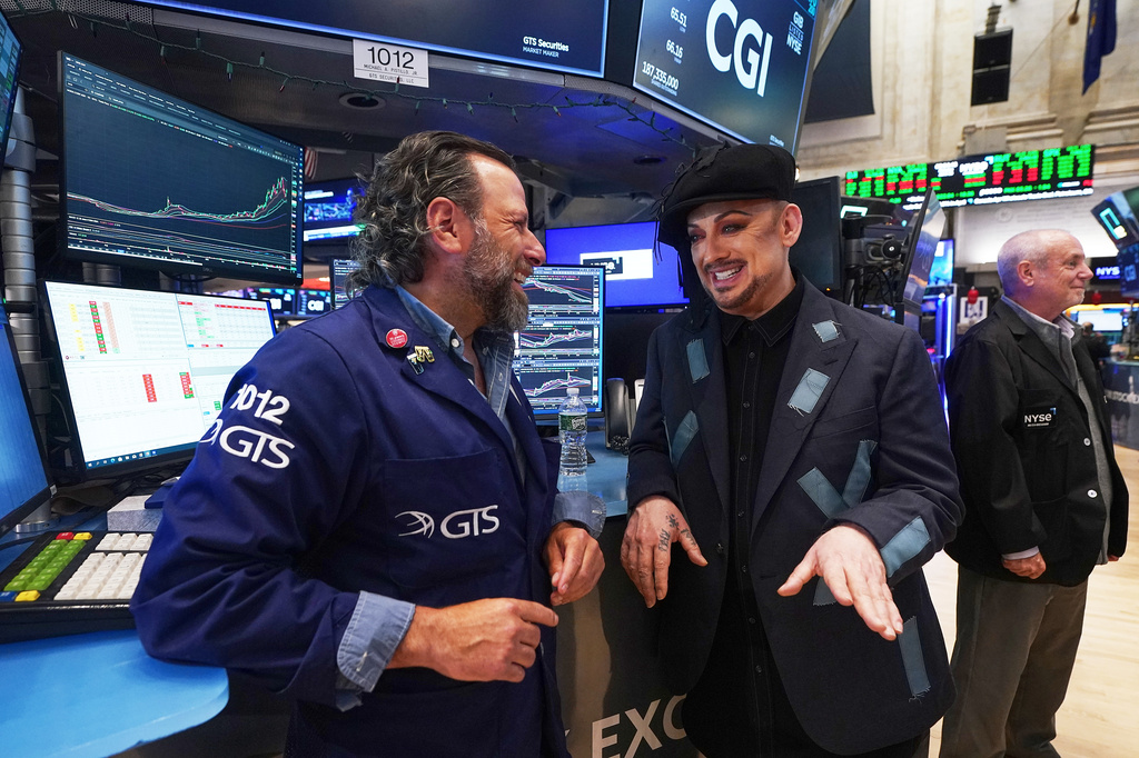 Singer Boy George, right, who is re-releasing "Karma Chameleon," talks with specialist Michael Pistillo during his visit to the floor of the New York Stock Exchange, Monday, June 15, 2026. (AP Photo/Richard Drew)