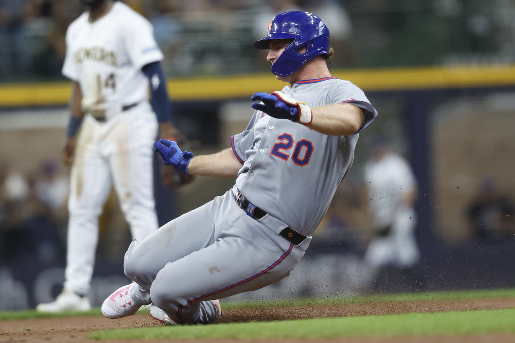 New York Mets' Pete Alonzo slides into second base with a double during the third inning of a baseball game against the Milwaukee Brewers, Sunday, Aug.10, 2025, in Milwaukee. (AP Photo/Jeffrey Phelps)