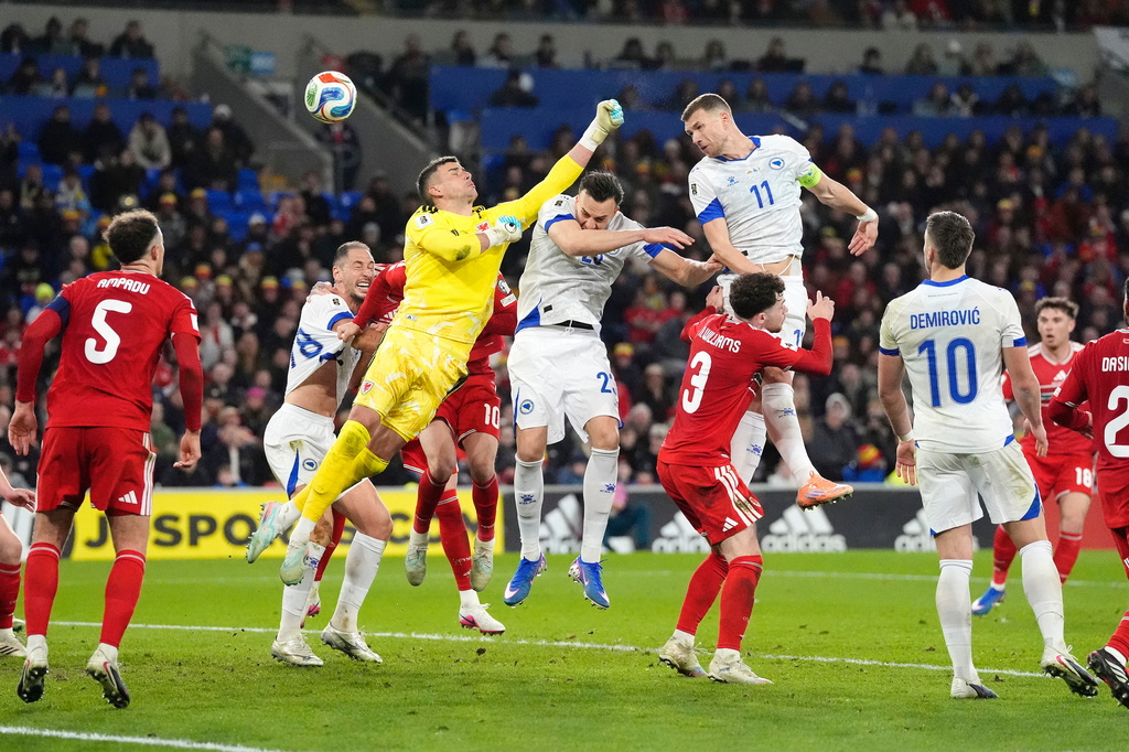 Bosnia and Herzegovina's Edin Dzeko, top right, scores their side's first goal during the World Cup playoff semifinal soccer match between Wales and Bosnia and Herzegovina in Cardiff, Wales, Thursday, March 26, 2026. (Nick Potts/PA via AP)