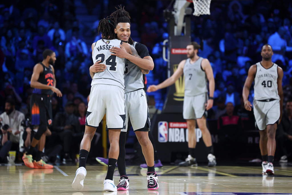 San Antonio Spurs guard Devin Vassell (24) and Stephon Castle react after a basket against the New York Knicks during the second half of the NBA Cup championship basketball game Tuesday, Dec. 16, 2025, in Las Vegas. (AP Photo/Ian Maule)