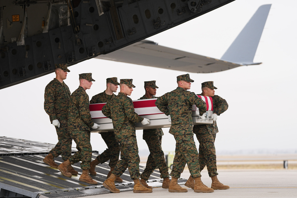 A Marine Corps carry team moves the transfer case containing the remains of U.S. Marine Corps Lance Cpl. Kevin Melendez of Fort Worth, Texas, Wednesday March 4, 2026, at Dover Air Force Base, Del. (AP Photo/Matt Rourke)