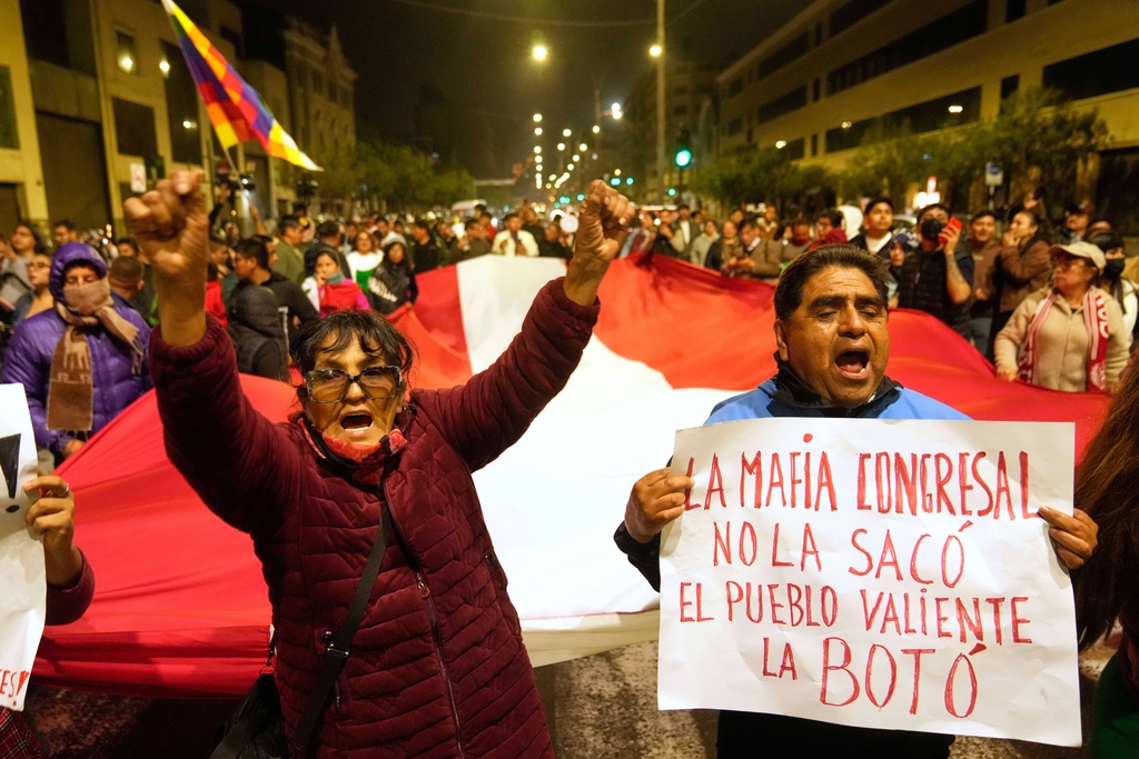 Anti-government demonstrators celebrate outside the congress building in Lima, Peru, Friday, Oct. 10, 2025 as Peru's Congress voted to remove President Dina Boluarte from office. (AP Photo/Martin Mejia)