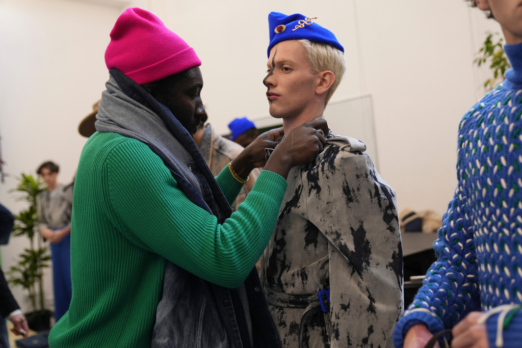 Ghanaian-born fashion designer Victor Reginald Bob Abbey-Hart prepares models backstage at the Victor-Hart Fall/Winter 2026-2027 Men's fashion show in Milan, Italy, Jan. 18, 2026. (AP Photo/Antonio Calanni)