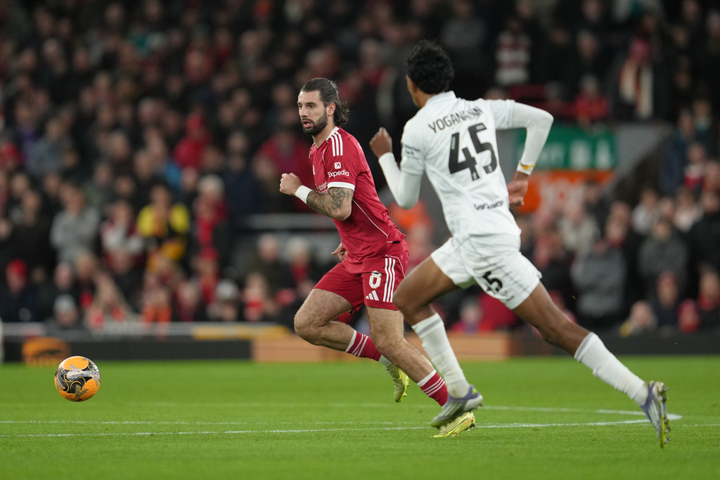 Barnsley's Vimal Yoganathan guards Liverpool's Dominik Szoboszlai during the FA Cup third round soccer match between Liverpool and Barnsley in Liverpool, England, Monday, Jan. 12, 2026. (AP Photo/Jon Super)
