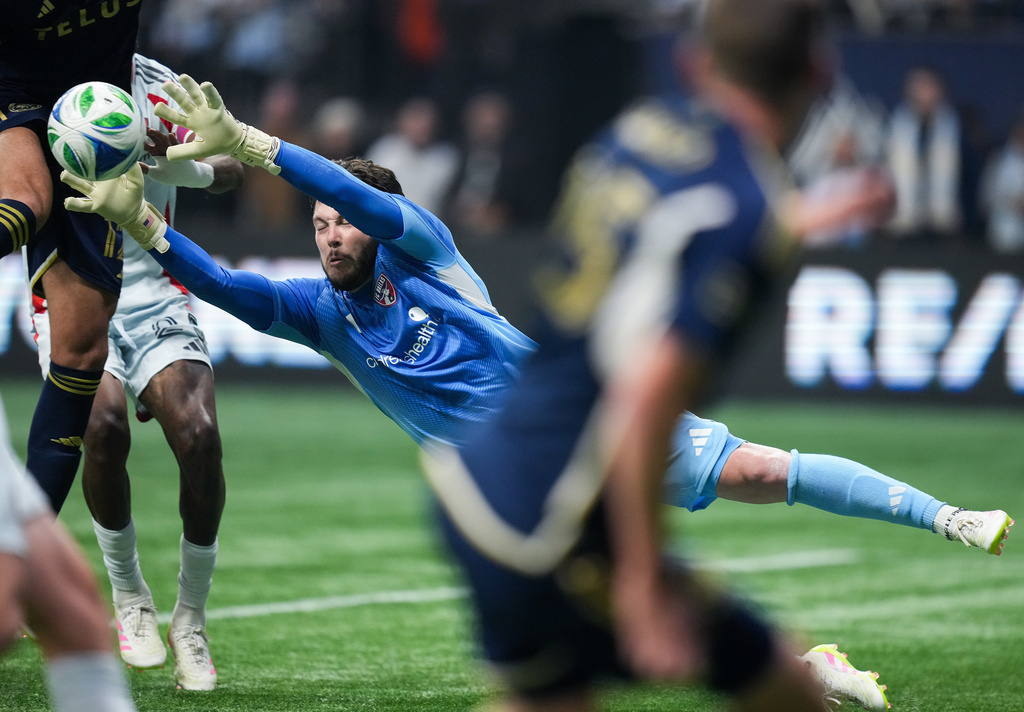 FC Dallas goalkeeper Michael Collodi makes a save during the second half of an MLS soccer match against the Vancouver Whitecaps in Vancouver, British Columbia, Saturday, Oct. 18, 2025. (Darryl Dyck/The Canadian Press via AP)