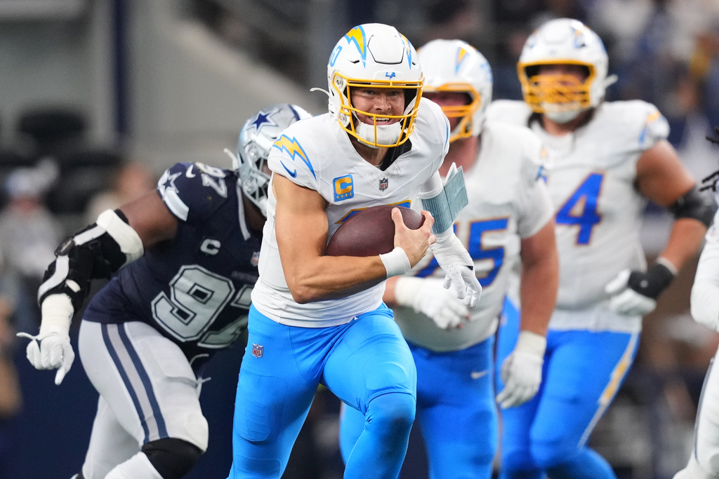 Los Angeles Chargers quarterback Justin Herbert (10) runs during the second half of an NFL football game against the Dallas Cowboys, Sunday, Dec. 21, 2025, in Arlington, Texas. (AP Photo/Julio Cortez)