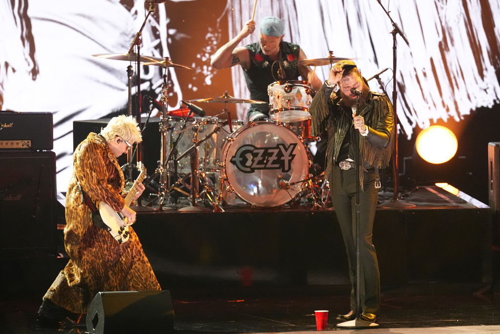 Andrew Watt, from left, Chad Smith, and Post Malone perrform "War Pigs" during the in memoriam tribute for the 68th annual Grammy Awards on Sunday, Feb. 1, 2026, in Los Angeles. (AP Photo/Chris Pizzello)