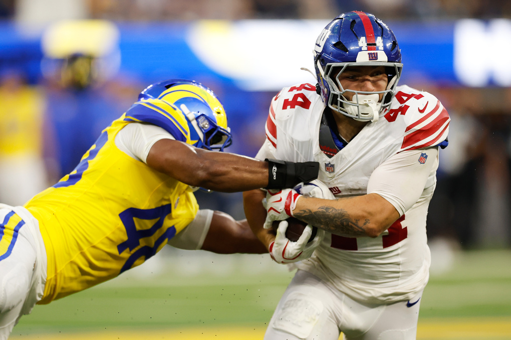 New York Giants running back Cam Skattebo (44) is tackled by Los Angeles Rams linebacker Omar Speights (48) during the first half of an NFL football game in Inglewood, Calif., Monday, Sept. 21, 2026. (AP Photo/Caroline Brehman)