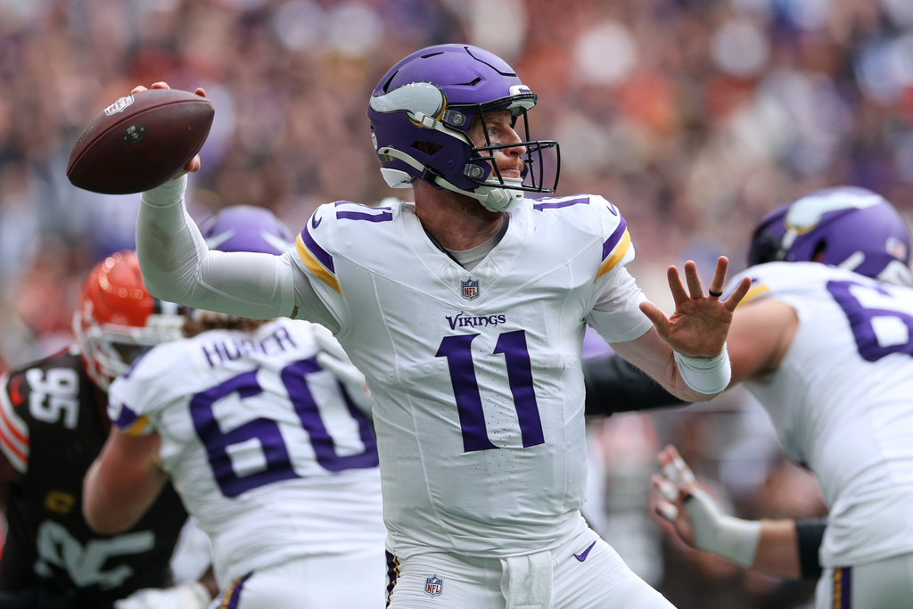 Minnesota Vikings quarterback Carson Wentz (11) passes the ball during the first half of the NFL game between Minnesota Vikings and Cleveland Browns at the Tottenham Hotspur stadium in London, Sunday, Oct. 5, 2025. (AP Photo/Ian Walton)