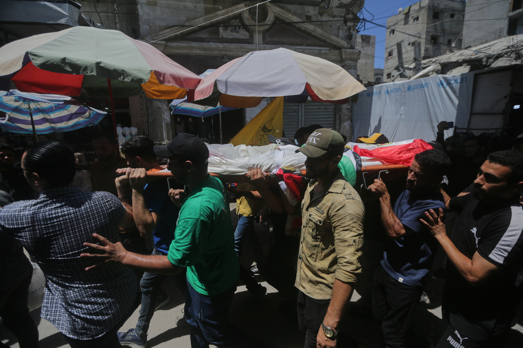 Palestinians carry the body of Mohamed al-Wahidi, director of public relations for the Egyptian Committee in Gaza, who was killed in an Israeli military strike, during his funeral in Gaza City, Wednesday, July 8, 2026. (AP Photo/Yousef Al Zanoun)