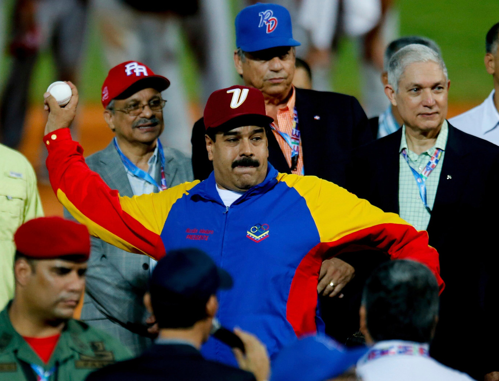 FILE - Venezuela's President Nicolas Maduro winds up to pitch a ball during the opening ceremony of the Caribbean Series baseball tournament in Porlamar, Venezuela, Feb. 1, 2014. (AP Photo/Fernando Llano, File)
