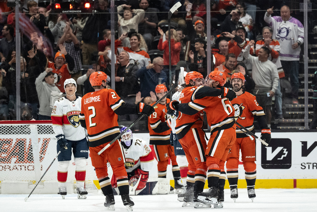 Anaheim Ducks players celebrate a goal by left wing Cutter Gauthier (61) during the second period of an NHL hockey game against the Florida Panthers, Tuesday, Nov. 4, 2025, in Anaheim, Calif. (AP Photo/Kyusung Gong)
