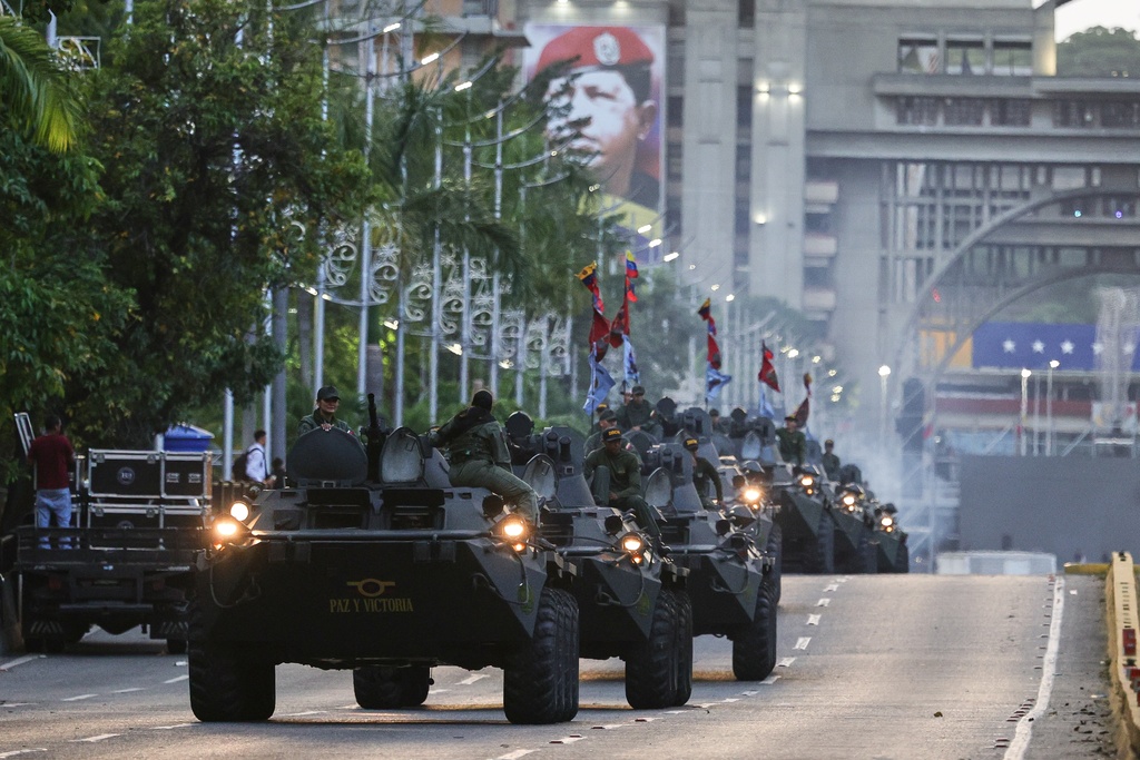 Armored vehicles drive through a street during a government-organized march in support of President Nicolas Maduro in Caracas, Venezuela, Tuesday, Sept. 23, 2025. (AP Photo/Jesus Vargas)