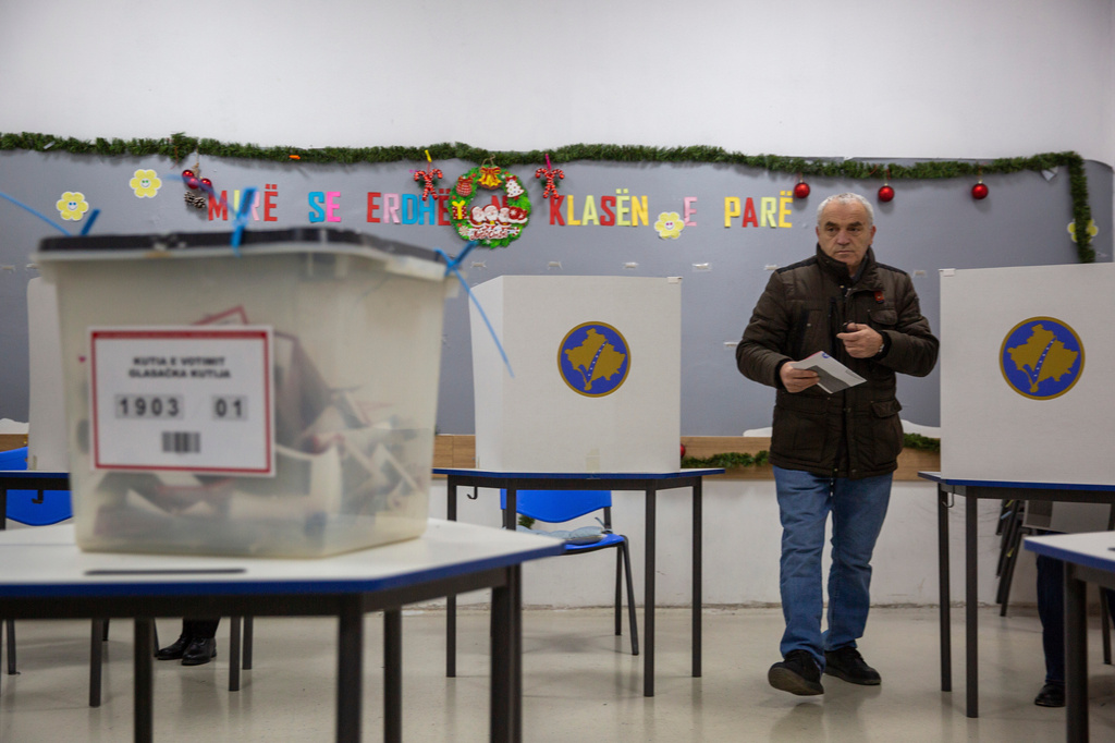 FILE - A man holds his ballot prior to voting in early parliamentary election in Kosovo's capital Pristina, on Dec. 28, 2025. (AP Photo/Visar Kryeziu, File)