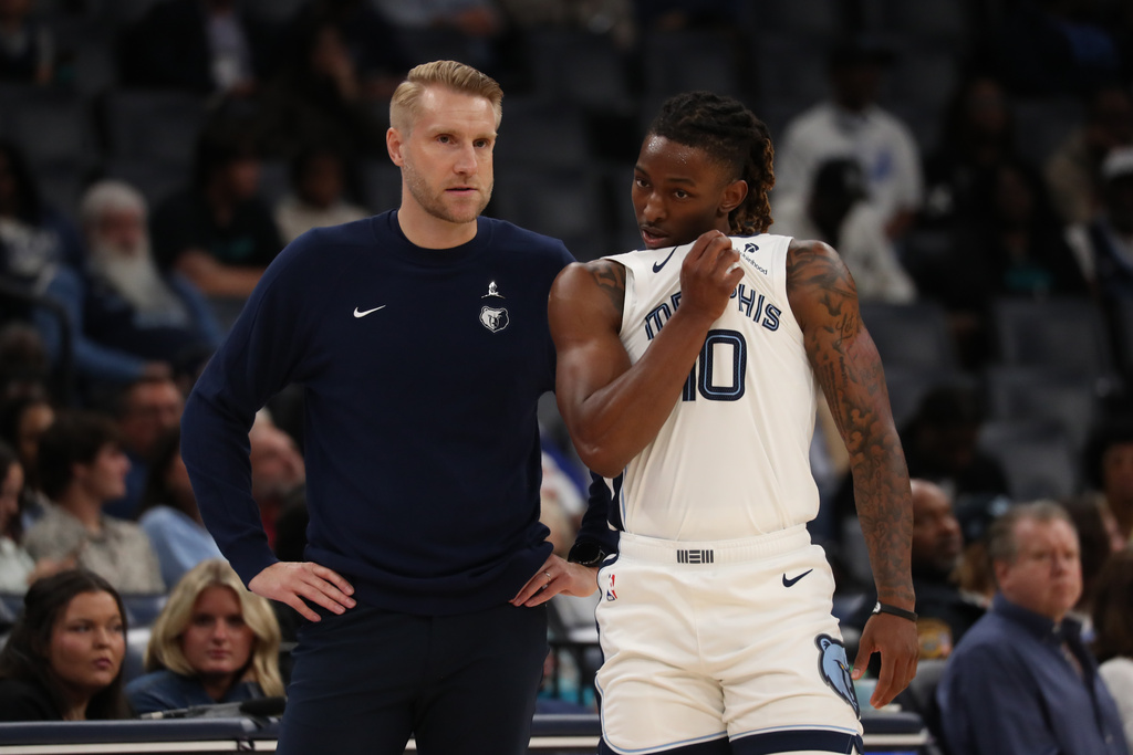 Memphis Grizzlies head coach Tuomas Iisalo, left, instructs guard Javon Small (10) in the first half of a preseason NBA basketball game against the Atlanta Hawks, Saturday, Oct. 11, 2025, in Memphis, Tenn. (AP Photo/Nikki Boertman)
