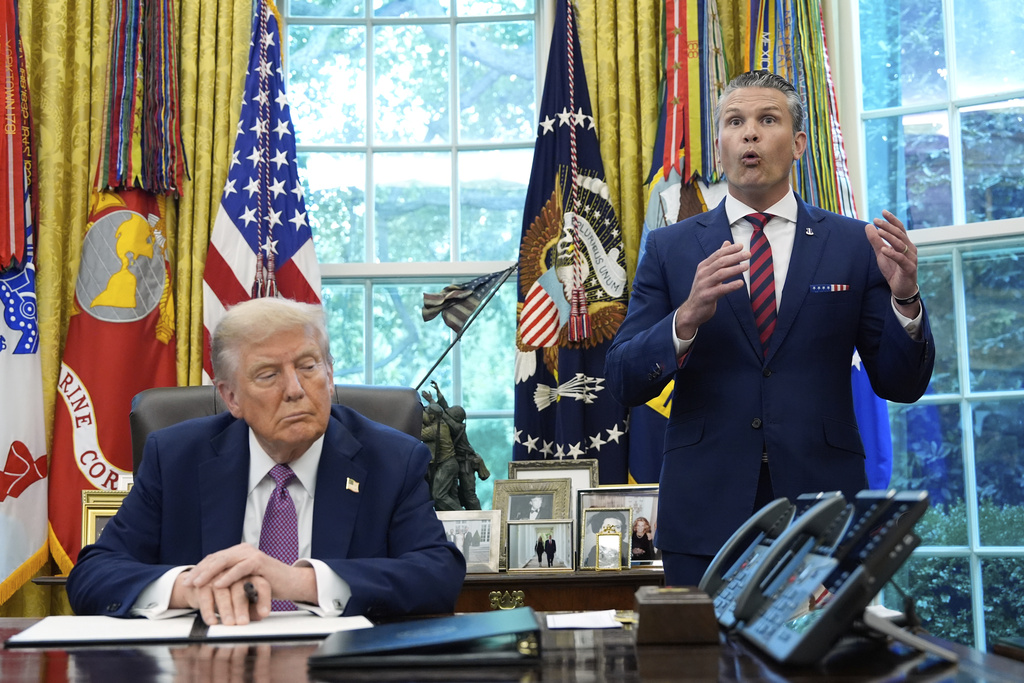 President Donald Trump listens as Defense Secretary Pete Hegseth speaks in the Oval Office of the White House, Friday, Sept. 5, 2025, in Washington. (AP Photo/Alex Brandon)