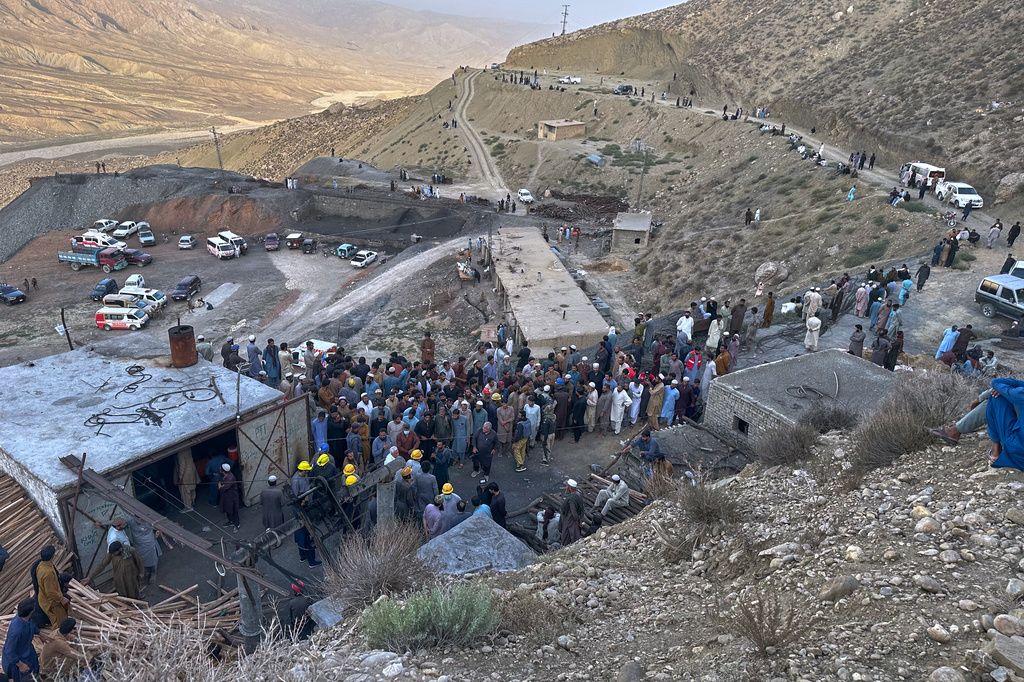People gather as rescue workers attempt to reach miners trapped in a coal mine on the outskirts of Quetta, the capital of Baluchistan province, in southwest Pakistan, Thursday, July 30, 2026. (AP Photo/Fazal Tawab)