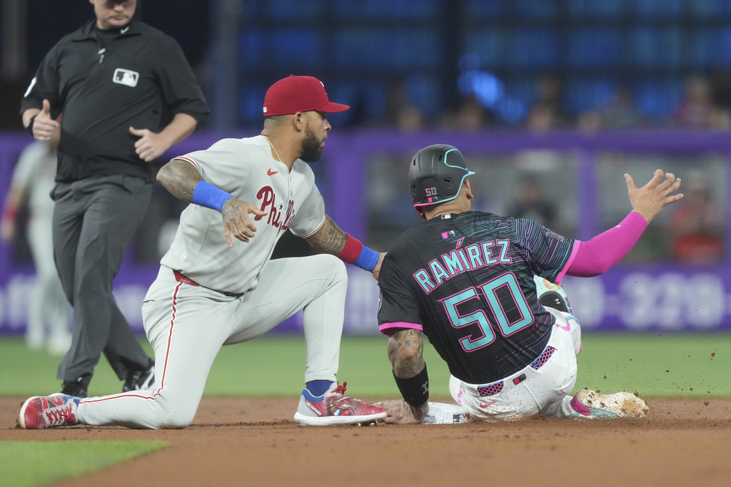 Philadelphia Phillies second baseman Edmundo Sosa tags Miami Marlins' Agustín Ramírez (50) as he tries to steal the base during the first inning of a baseball game Saturday, Sept. 6, 2025, in Miami. (AP Photo/Marta Lavandier)