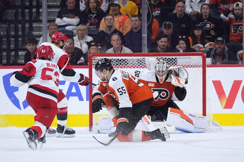 Carolina Hurricanes' Jackson Blake, left, scores the game-winning goal past Philadelphia Flyers' Dan Vladar (80) and Rasmus Ristolainen (55) in overtime during Game 4 in a second-round NHL hockey Stanley Cup playoff series, Saturday, May 9, 2026, in Philadelphia. (AP Photo/Matt Slocum)