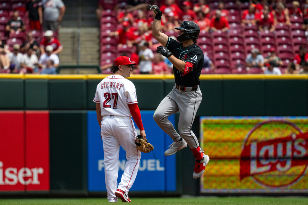 Arizona Diamondbacks Tommy Troy, right, celebrates after hitting a home run in the third inning of a baseball game against the Cincinnati Reds, Sunday, June 14, 2026, in Cincinnati. (AP Photo/Michael Swensen)