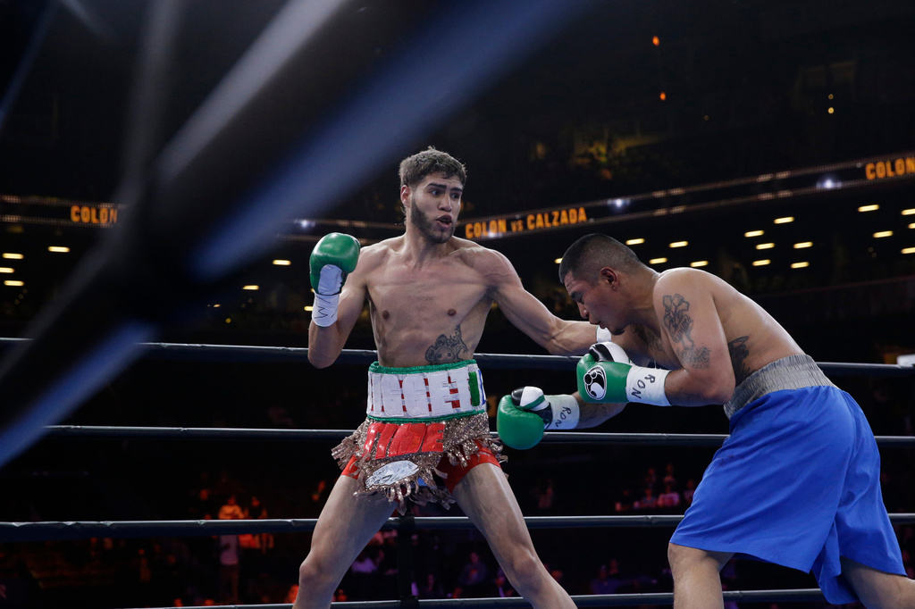 FILE - Prichard Colon, left, exchanges punches with Daniel Calzada during a junior middleweight title boxing match, Saturday, April 11, 2015, at New York. Colon won by TKO. (AP Photo/Mary Altaffer, file)