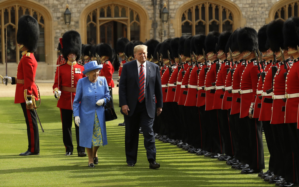 FILE - U.S. President Donald Trump and Britain's Queen Elizabeth II inspect a Guard of Honour, formed of the Coldstream Guards at Windsor Castle in Windsor, England, July 13, 2018.(AP Photo/Matt Dunham, Pool, File)