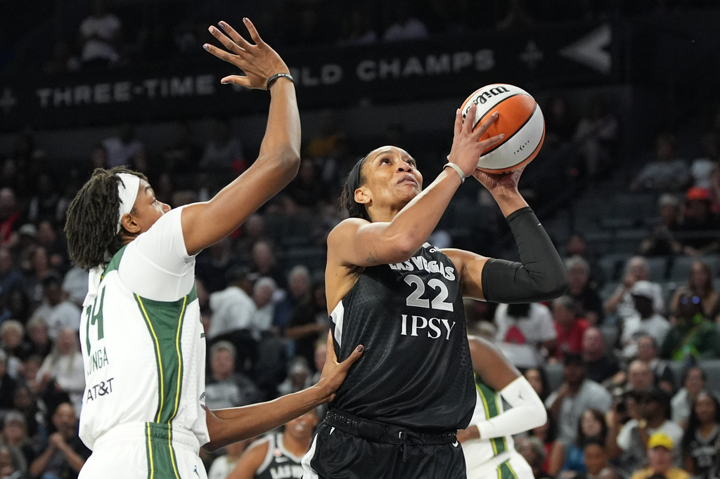Las Vegas Aces center A'ja Wilson (22) shoots over Seattle Storm center Dominique Malonga (14) during the first half of a WNBA basketball game Sunday, Sept. 20, 2026, in Las Vegas. (AP Photo/John Locher)