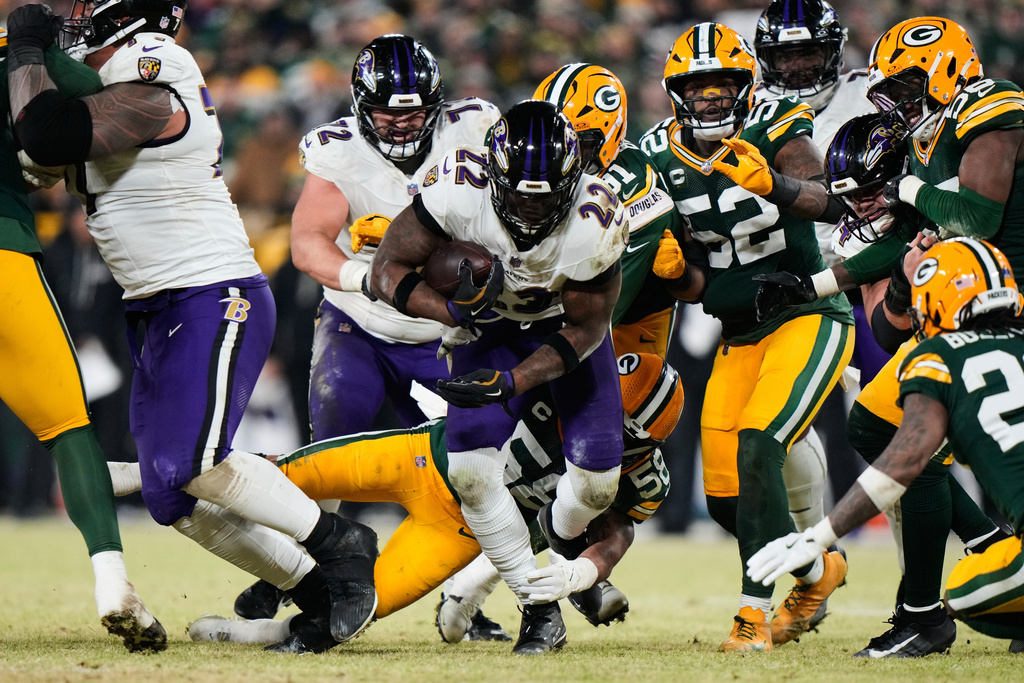Baltimore Ravens running back Derrick Henry (22) runs the ball against the Green Bay Packers during the second half of an NFL football game, Saturday, Dec. 27, 2025, in Green Bay, Wis. (AP Photo/Morry Gash)