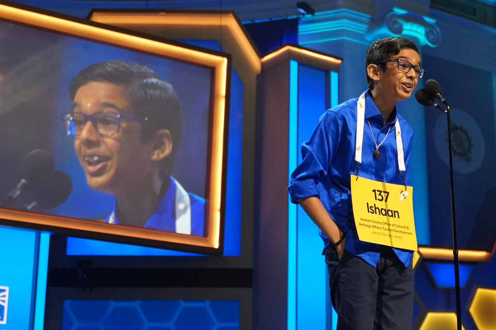 Ishaan Gupta, 12, of Jersey City, N.J., spells his word during the final round of the 2026 Scripps National Spelling Bee in Washington, Thursday, May 28, 2026. (AP Photo/Allison Robbert)